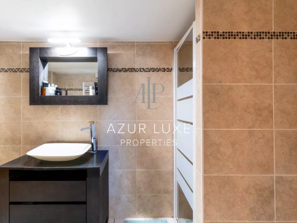 Modern bathroom with sink and mirror, beige tiles
