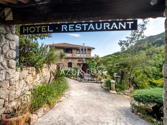 Entrance to a former stone hotel-restaurant with garden, located in Castillon.