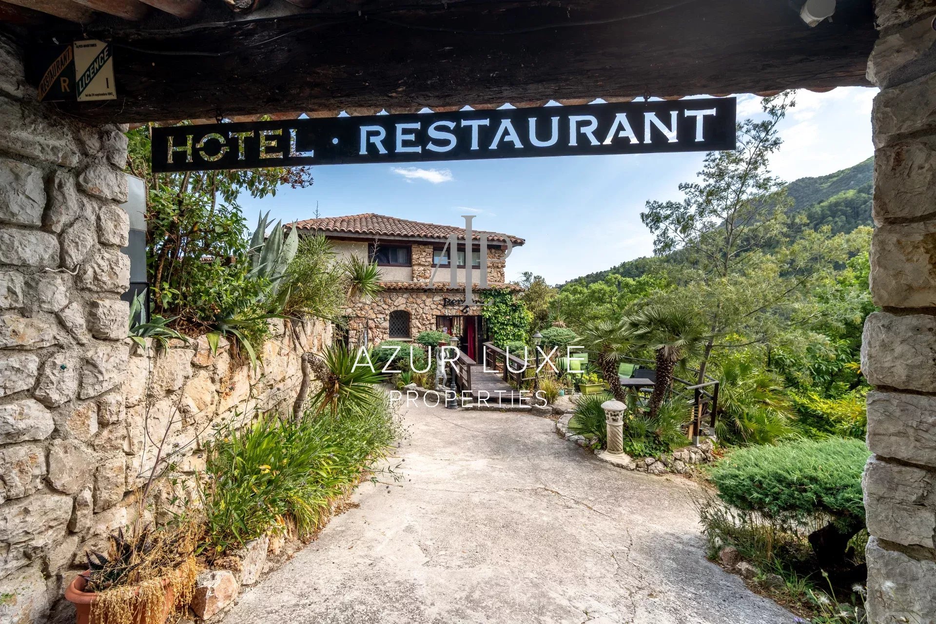 Former Hotel-Restaurant in Castillon Entrance to a former stone hotel-restaurant with garden, located in Castillon.