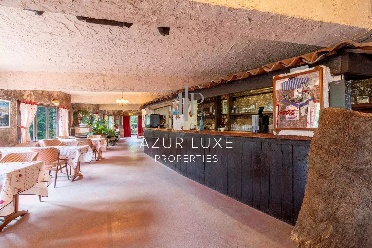 Interior of a former hotel-restaurant in Castillon Interior of a former hotel-restaurant with wooden tables and bar, warm atmosphere.