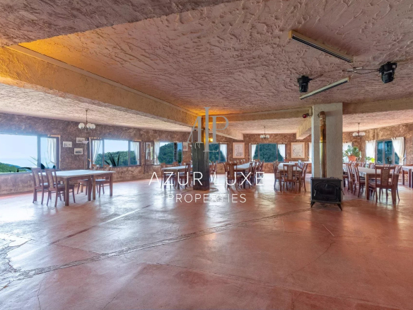 Interior of a former hotel-restaurant with large windows and sea view, located in Castillon.