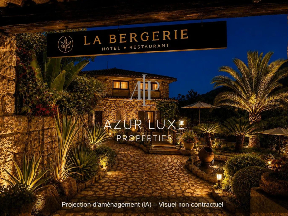 Entrance to a former hotel-restaurant with a garden, illuminated at night in Castillon.