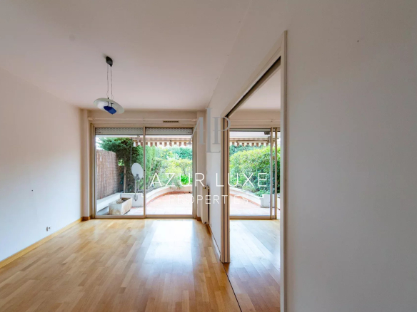 Interior of an apartment to be renovated with living room and access to a terrace, Beaulieu-sur-Mer.