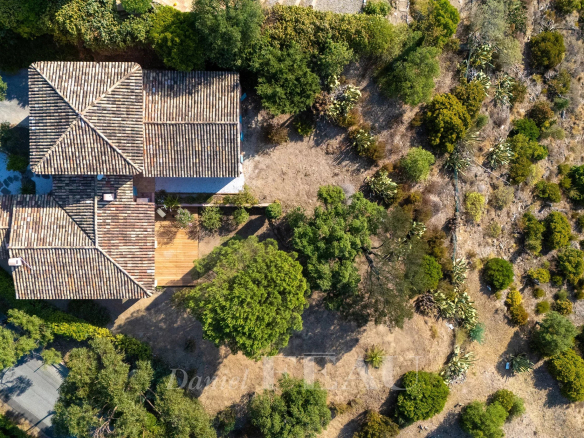 Aerial view of a villa in Rayol-Canadel-sur-Mer surrounded by greenery.