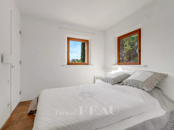 Room in a villa in Rayol-Canadel-sur-Mer with two windows and a double bed.