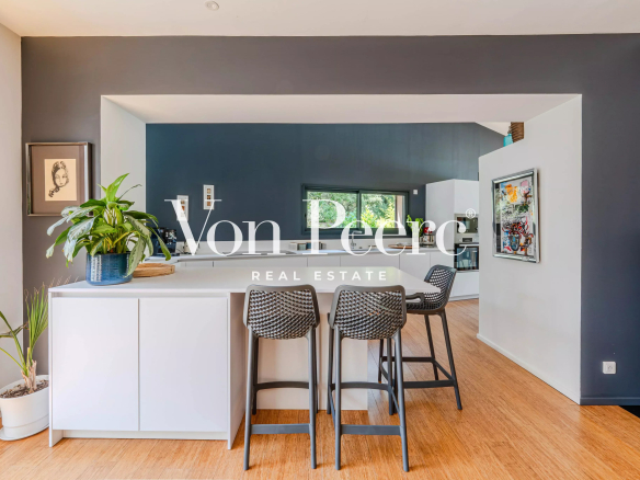Interior of a single-storey villa with open kitchen and dining area.