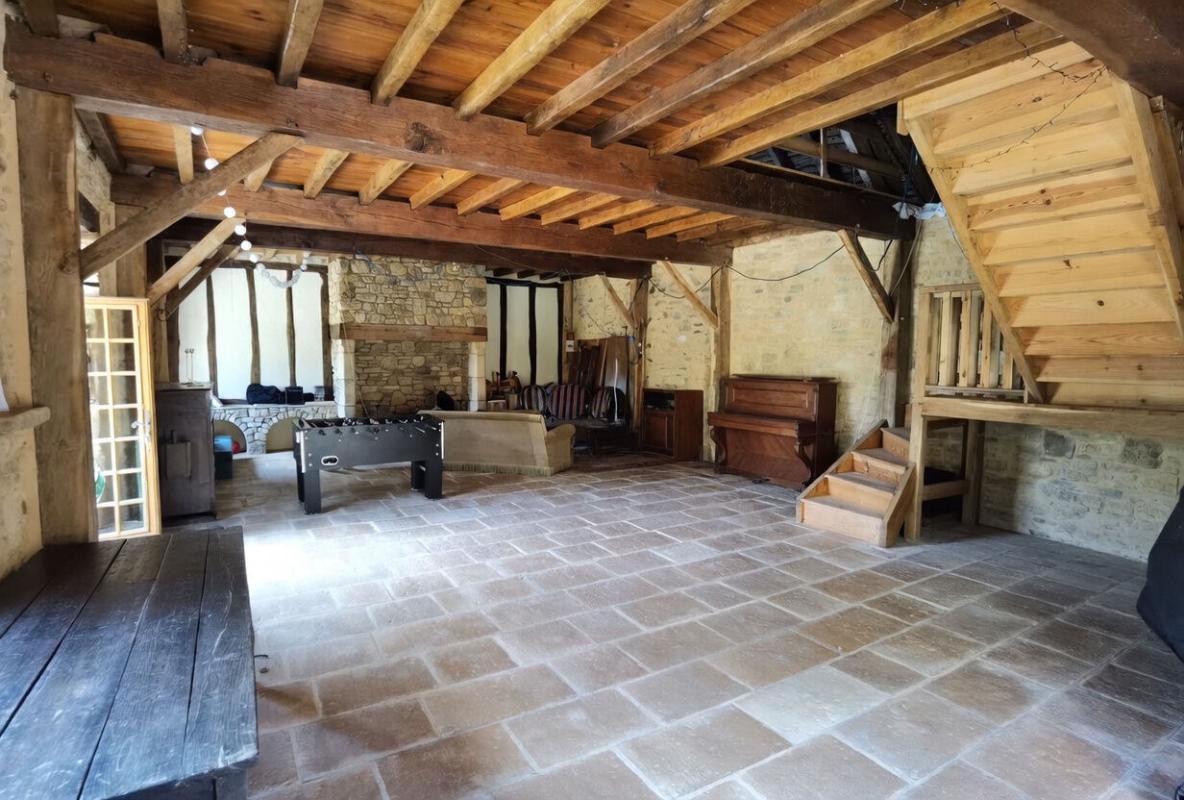 Interior of a stone barn Interior of a stone barn with exposed beams and open space.