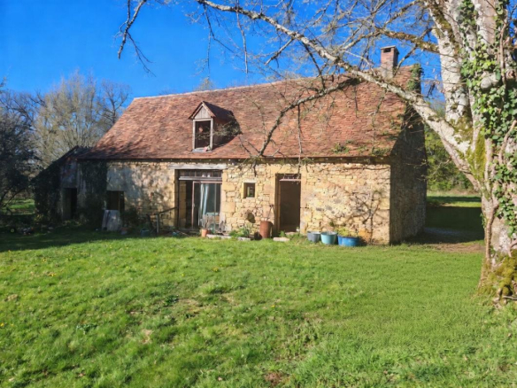 Former stone farmhouse with a green garden, Excideuil.
