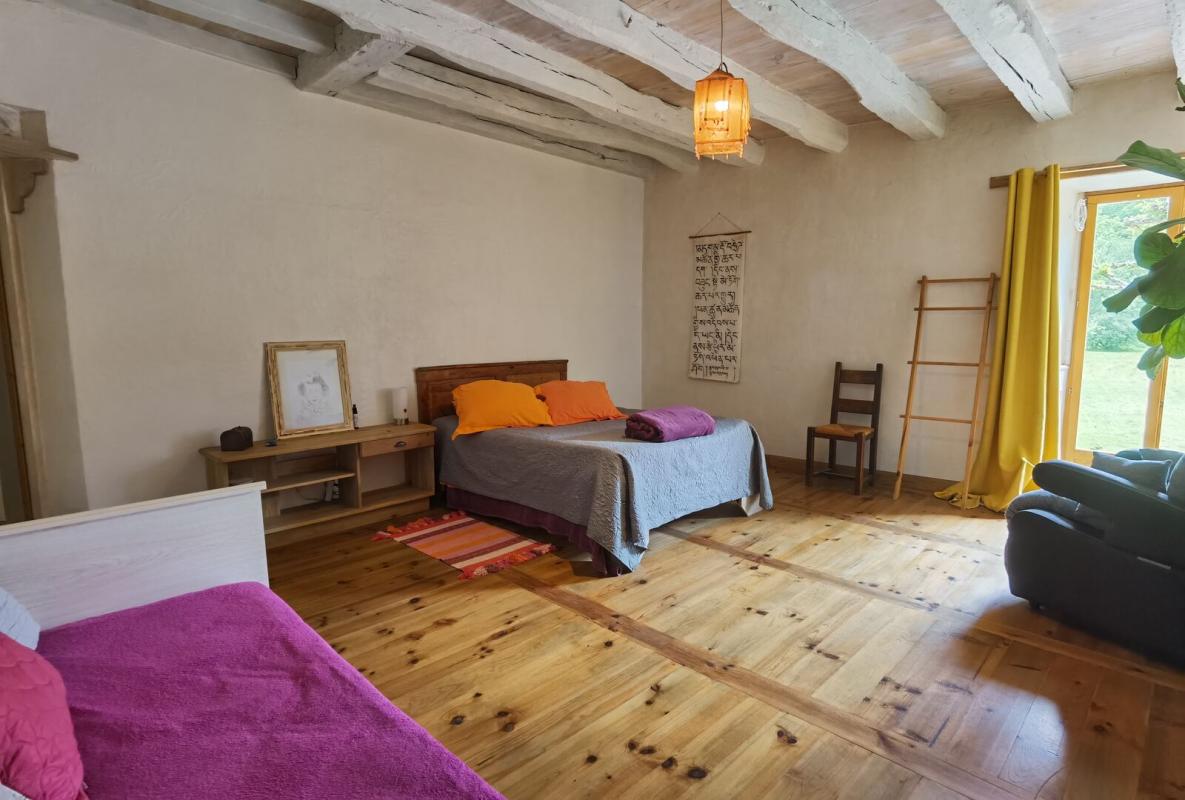 Room in a farmhouse Spacious room with beds, wooden furniture and natural light.