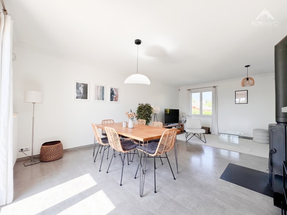 Interior of a modern house with a bright dining room and living room.
