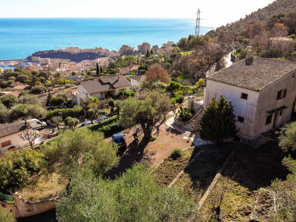 Provençal villa with sea views in La Turbie, surrounded by trees and gardens.