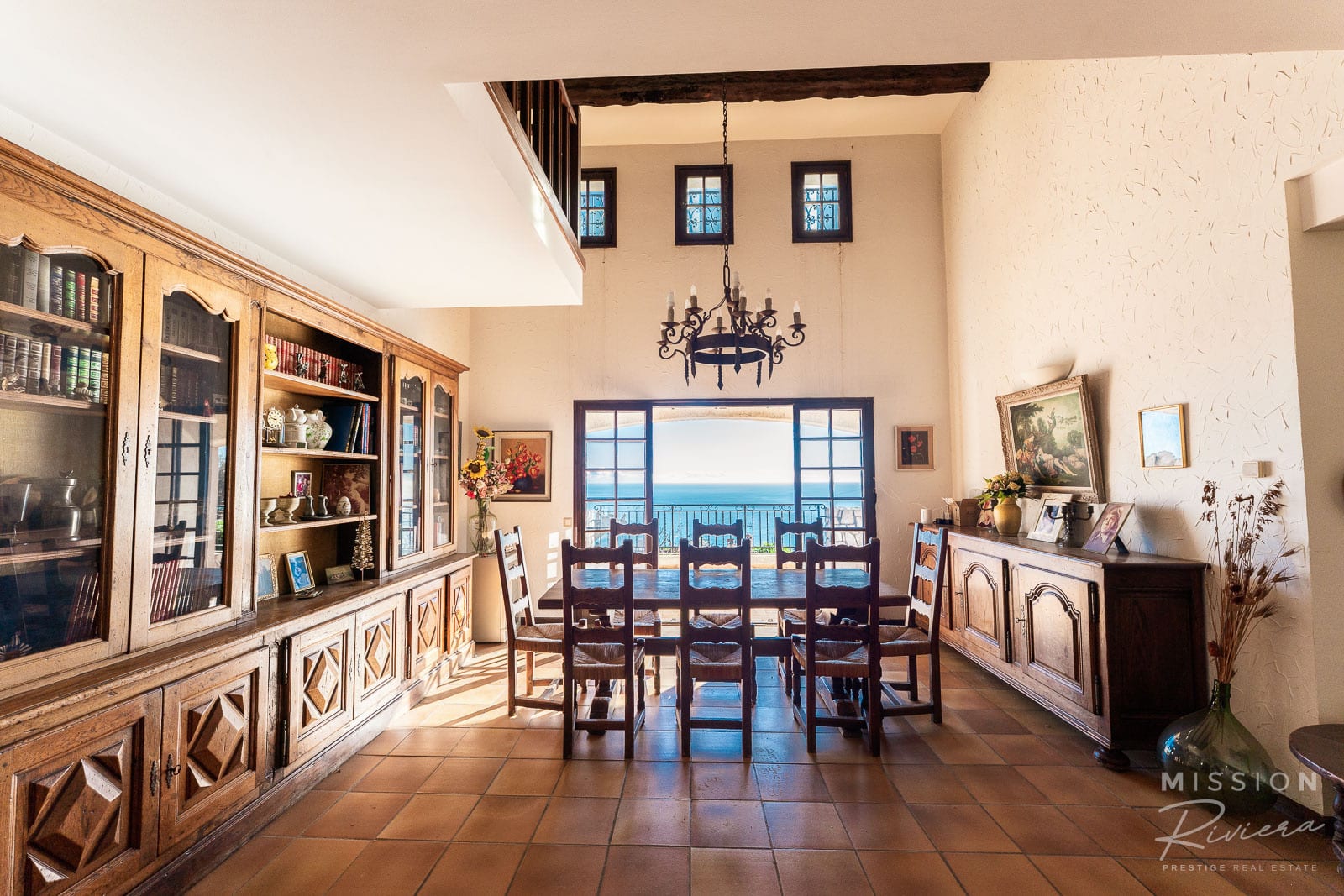 Interior of a Provençal villa in La Turbie Interior of a Provençal villa with sea view, dining room and wooden library.
