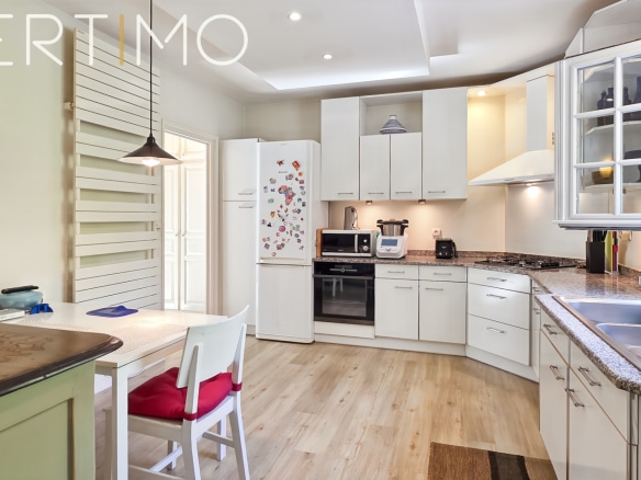 Modern and bright kitchen with dining table in a family property.