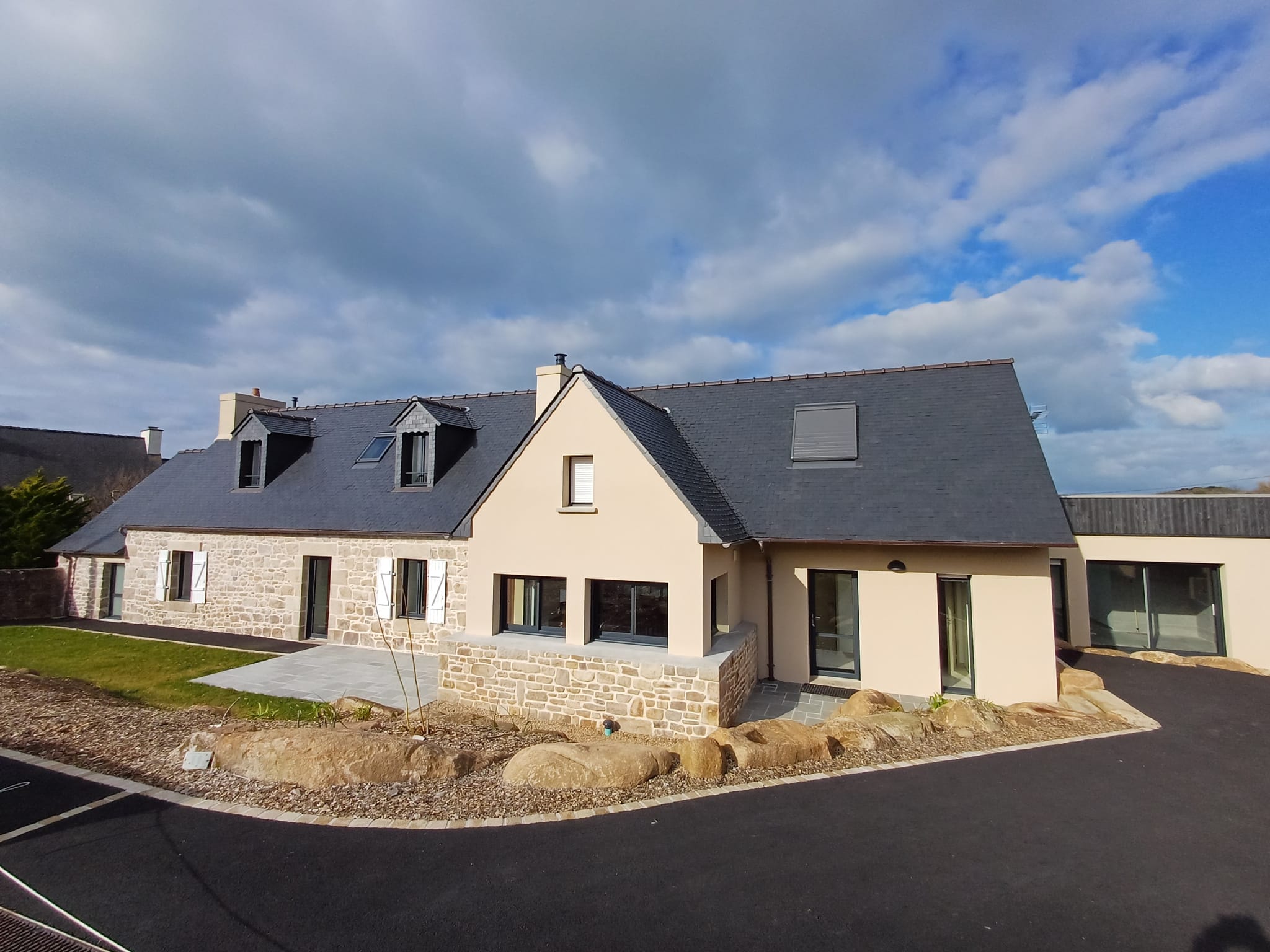 Recently rebuilt Breton stone house in Plougasnou, exterior view with garden.