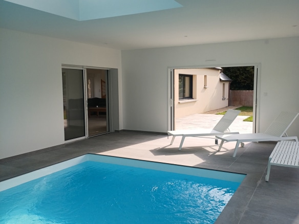 Interior of a renovated Breton house with swimming pool and access to the outside in Plougasnou.