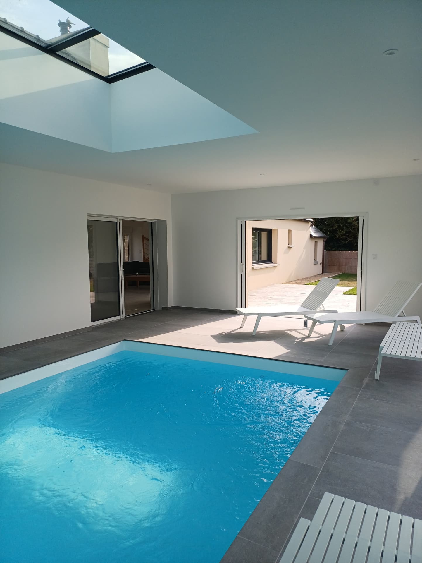 Interior of a renovated Breton house with swimming pool and access to the outside in Plougasnou.
