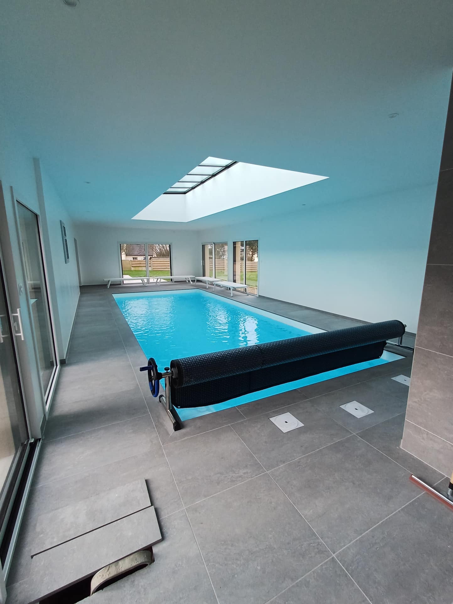Interior of a Breton house in Plougasnou with indoor swimming pool and large windows.