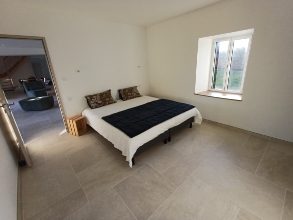 Bright room with a double bed and windows, Breton house in Plougasnou.