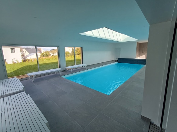 Interior of a Breton stone house with an indoor swimming pool in Plougasnou.