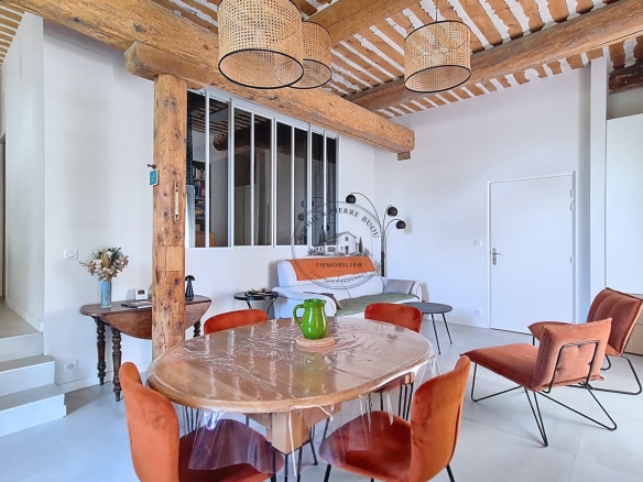 Interior of an 18th-century building with exposed beams and modern furniture.