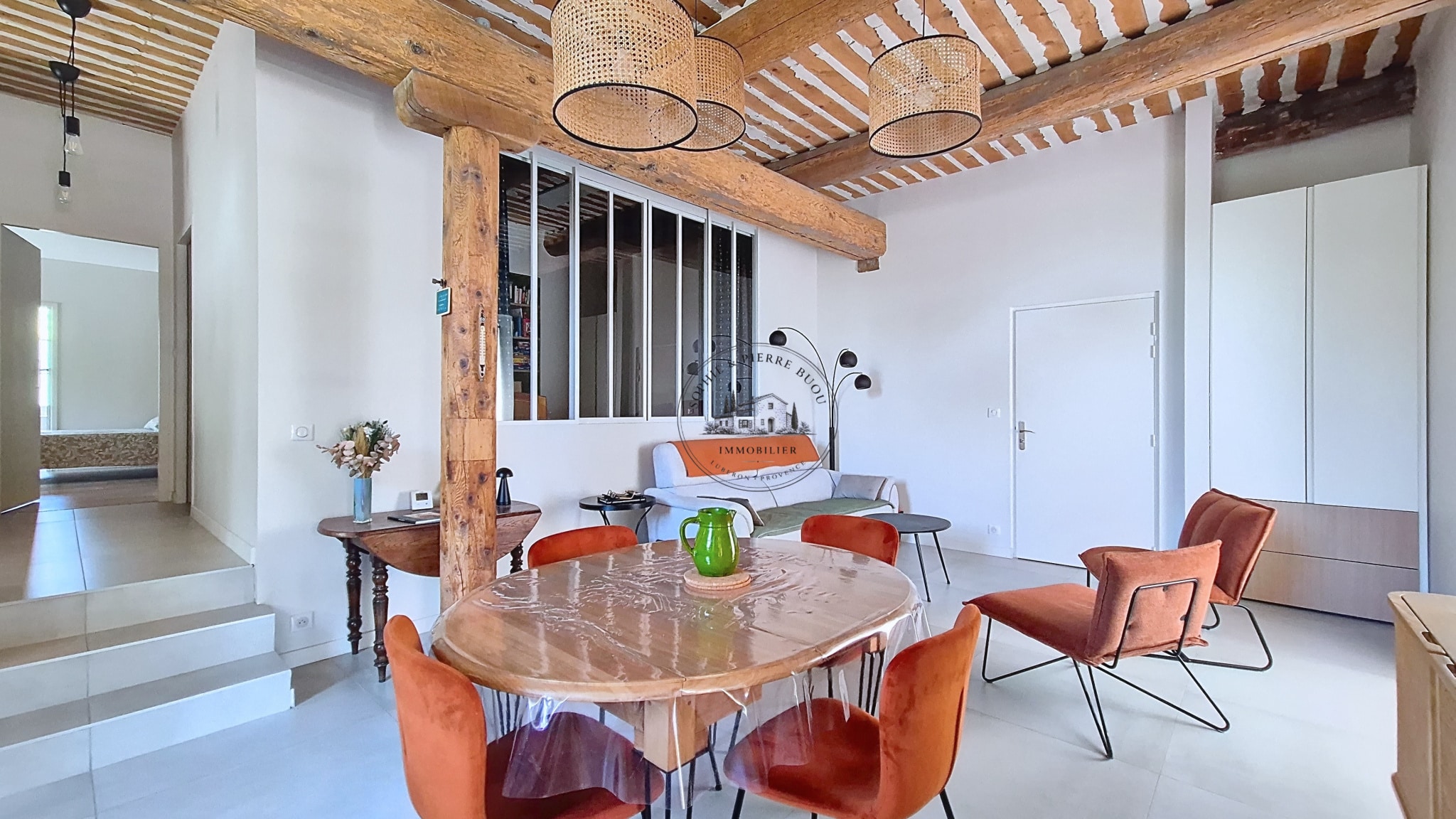 Interior of an 18th-century building with exposed beams and modern furniture.