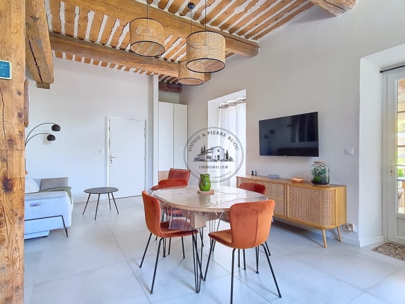 Interior of an 18th-century building with exposed beams and modern furniture.