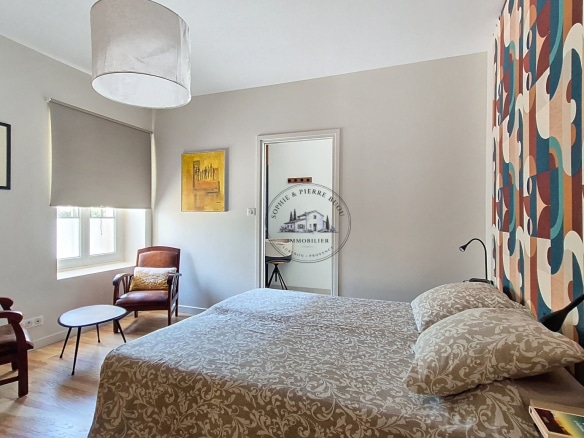 Room in an 18th-century building with modern decor and wooden furniture.
