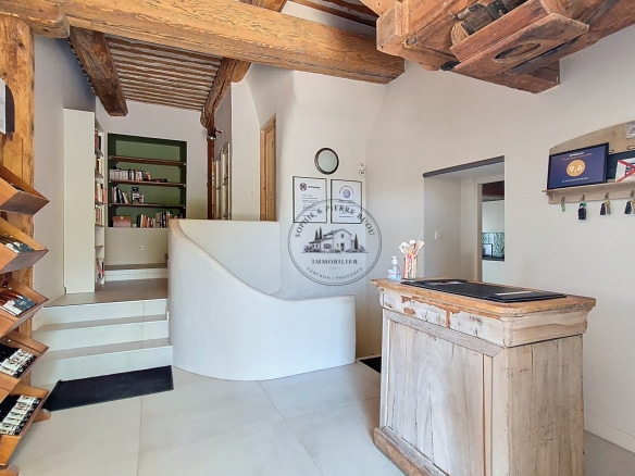 Interior of an 18th-century building with wooden elements and a reception area.