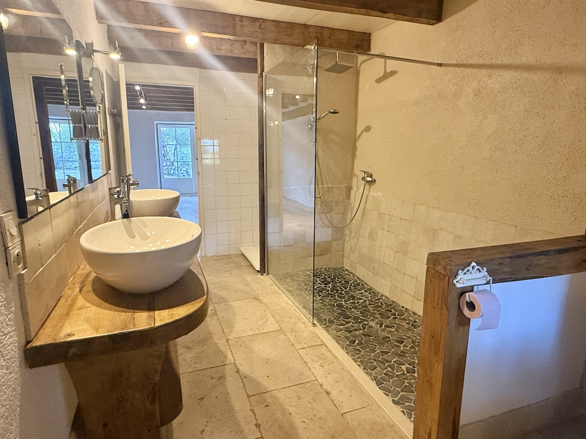 Modern bathroom with shower and stone sinks in a stone property in Touffailles.