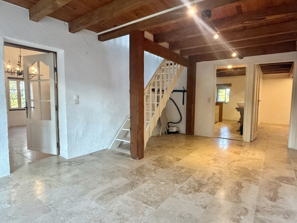 Interior of a stone property with staircase and tiling, in Touffailles.