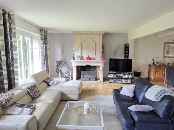 Bright living room with sofa and fireplace in a town house in Bauvin.