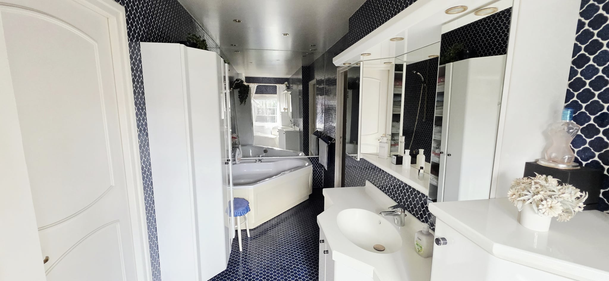 Elegant bathroom Modern bathroom with bathtub and double vanity, blue and white tiles