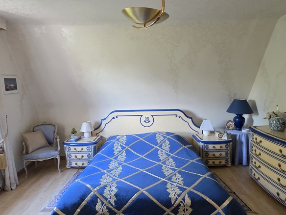 Bedroom with blue bed and matching furniture in a characterful house in Bauvin.