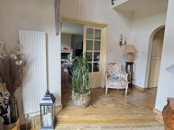Interior of a townhouse with entrance hall and wooden staircase.