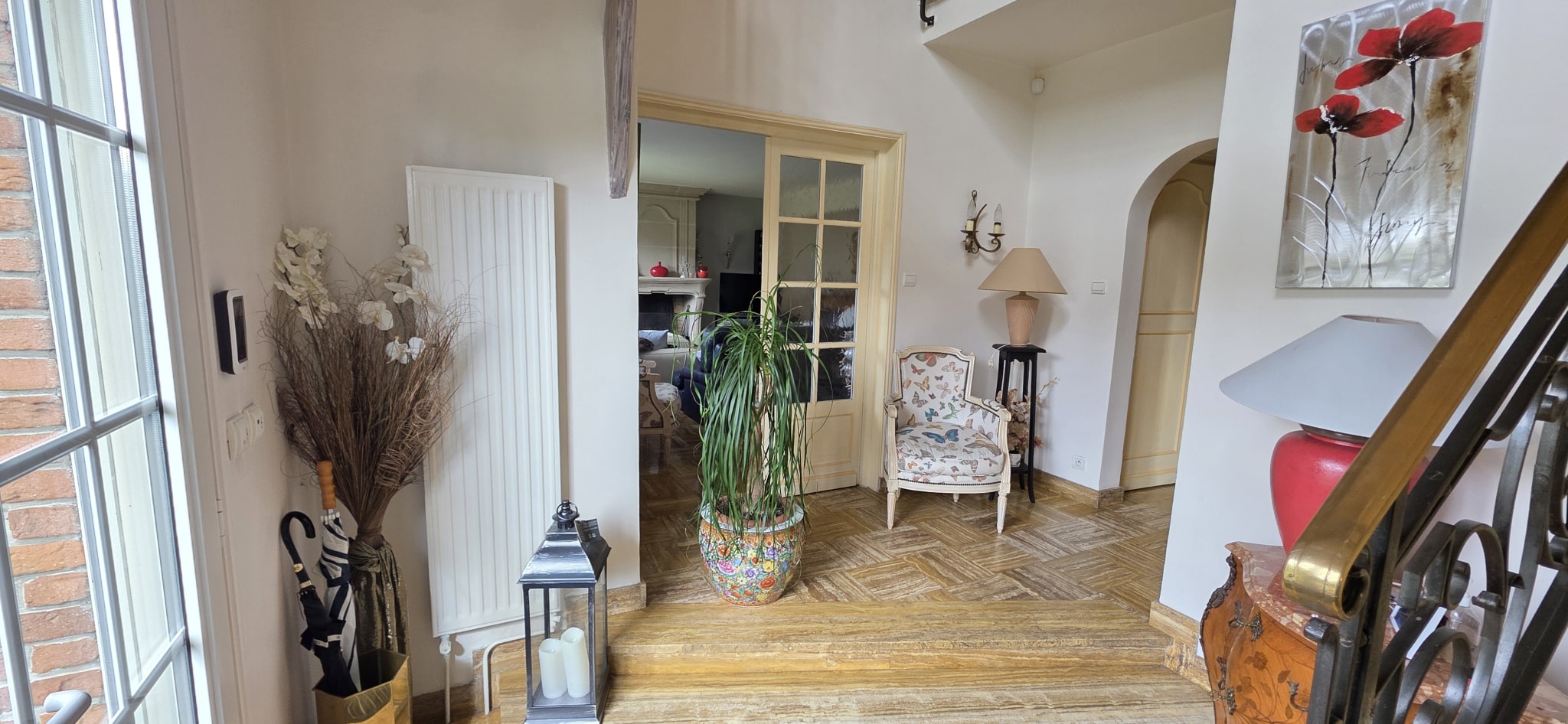 Entrance hall of a townhouse in Bauvin Interior of a townhouse with entrance hall and wooden staircase.