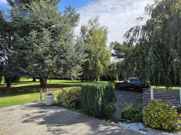 Entrance to a house with a garden and trees, Bauvin.