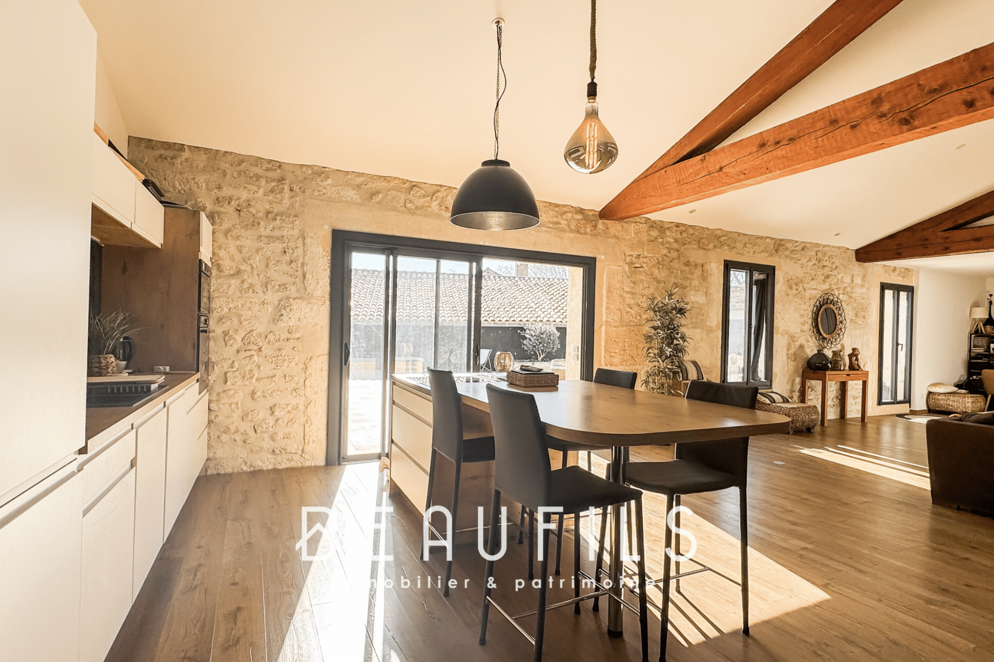 Interior of an atypical 191m2 loft in Mauguio, with open kitchen and bright living area.