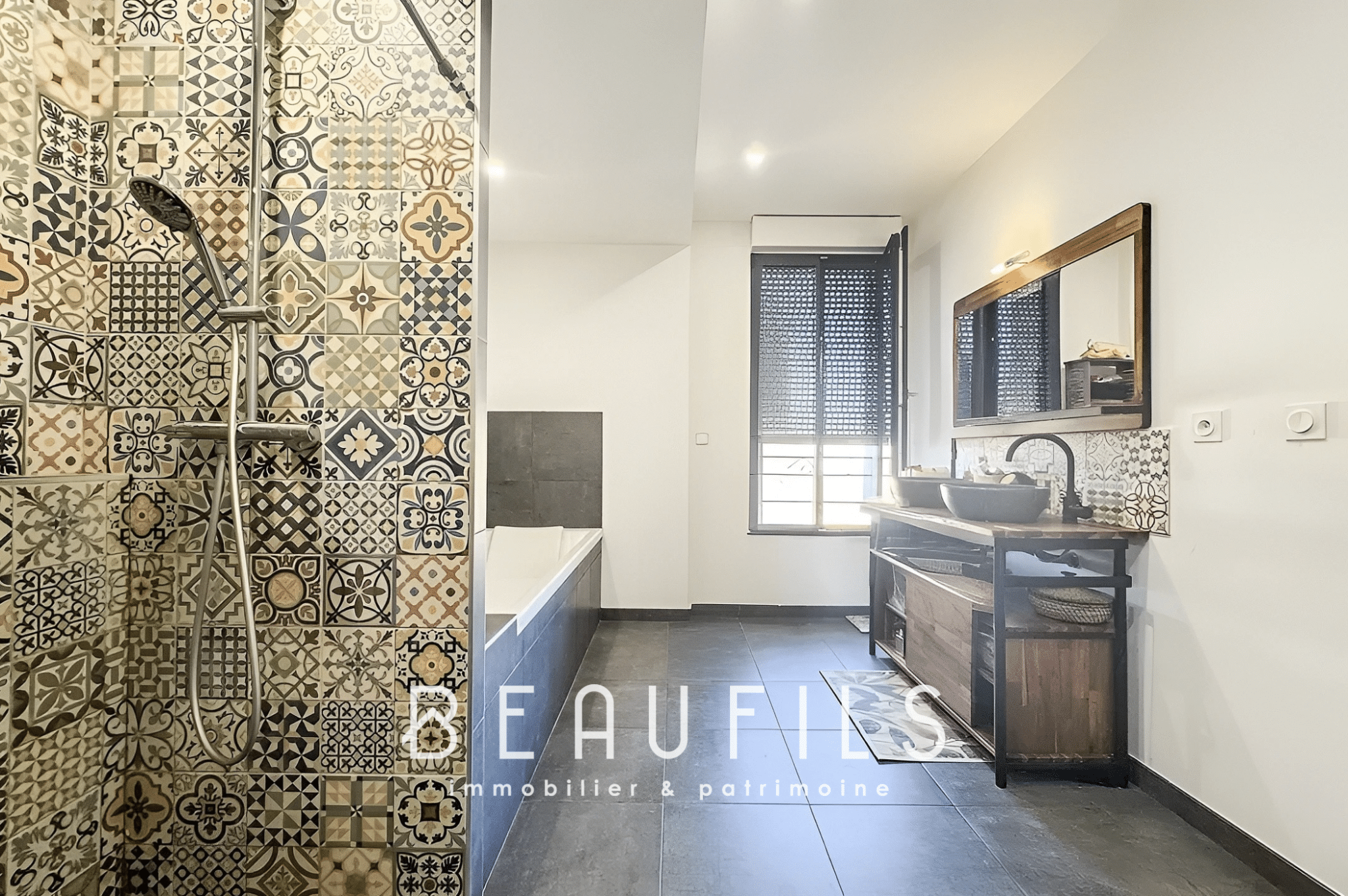 Bathroom with decorative tiles, bathtub and wooden furniture.