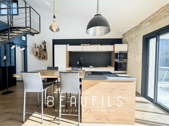 Interior of a modern loft with open kitchen and bright living space in Mauguio.