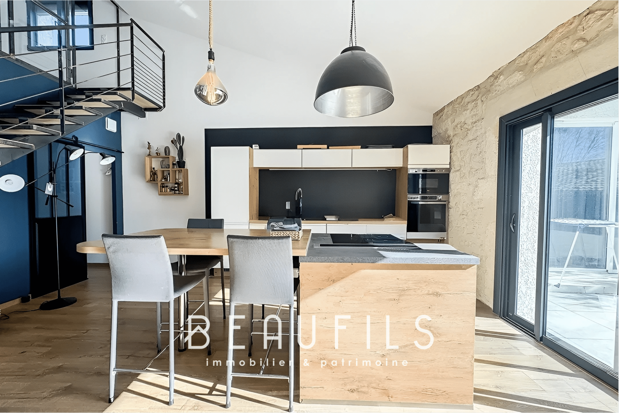 Interior of a modern loft with open kitchen and bright living space in Mauguio.