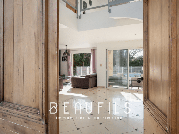 Interior of an architect-designed villa in Nîmes, view from the entrance with a bright living room.