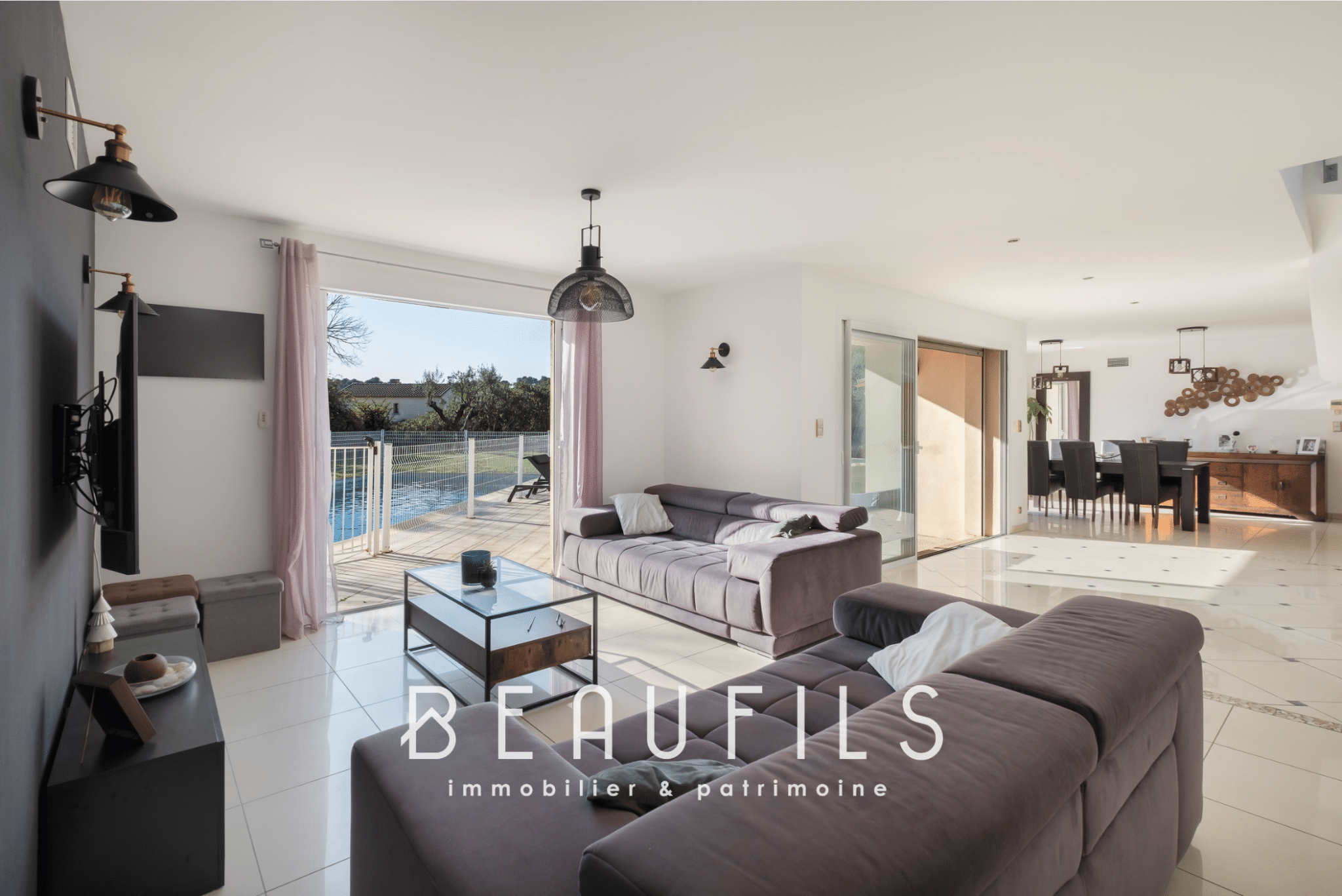 Interior of a modern villa with living room, open kitchen and access to the outside.