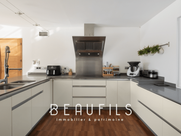 Modern kitchen in an architect-designed villa with clear worktops and contemporary equipment.