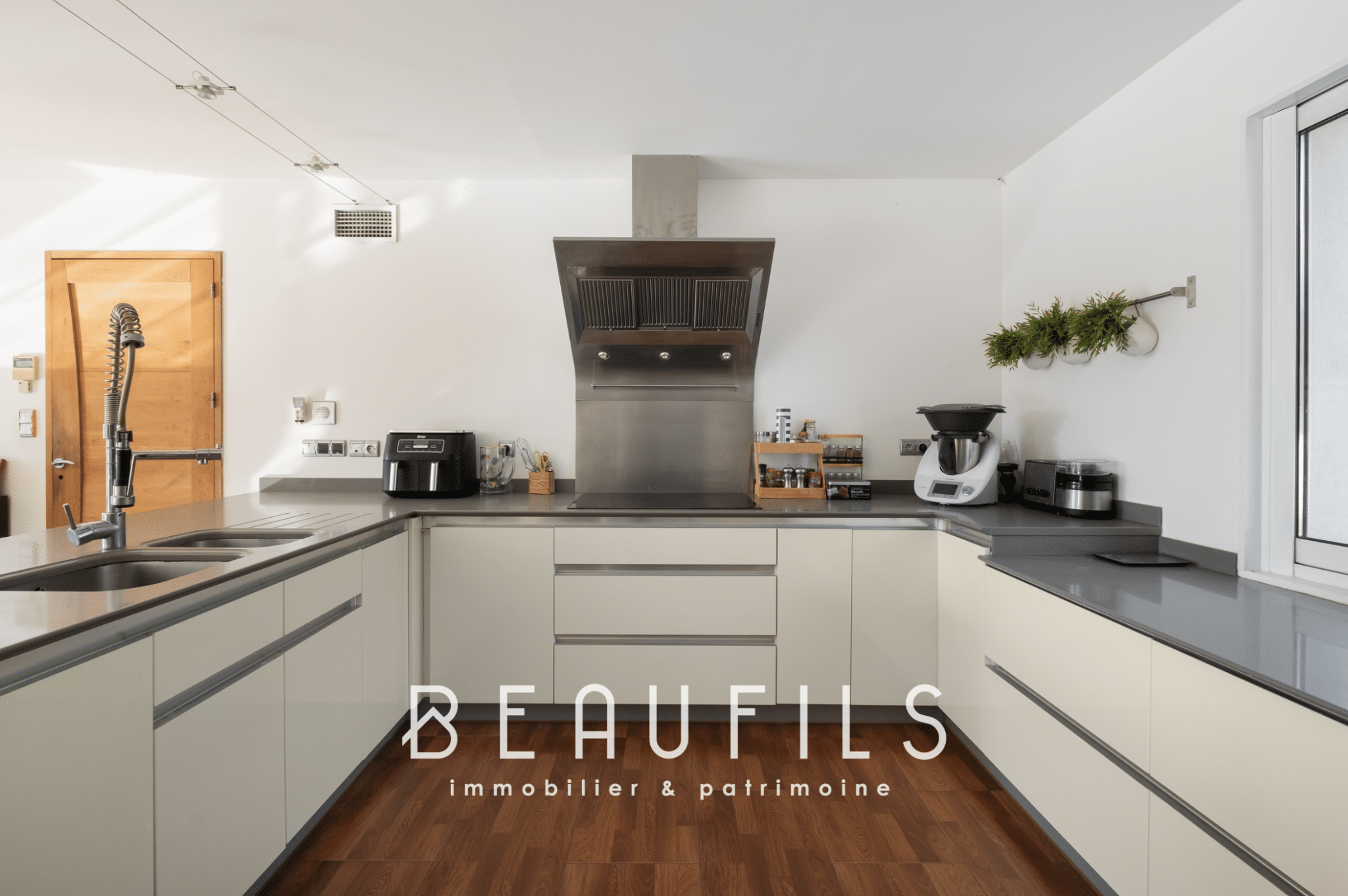 Modern kitchen in an architect-designed villa with clear worktops and contemporary equipment.