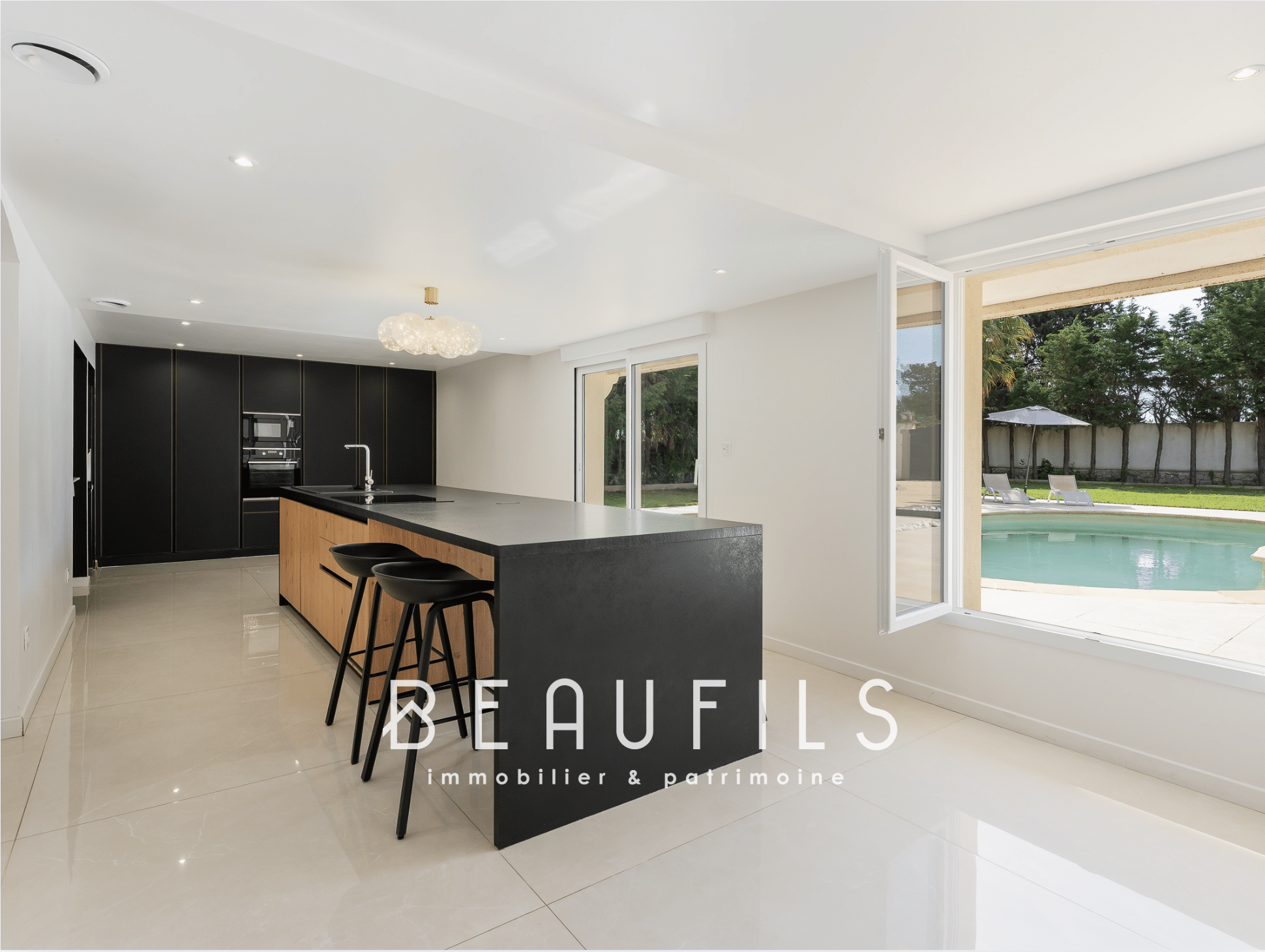 Modern kitchen with central island in a renovated neo-Provençal farmhouse in Saint-Gilles, Nîmes.