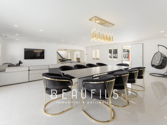 Interior of a renovated neo-Provençal farmhouse with a modern dining room and spacious living room.