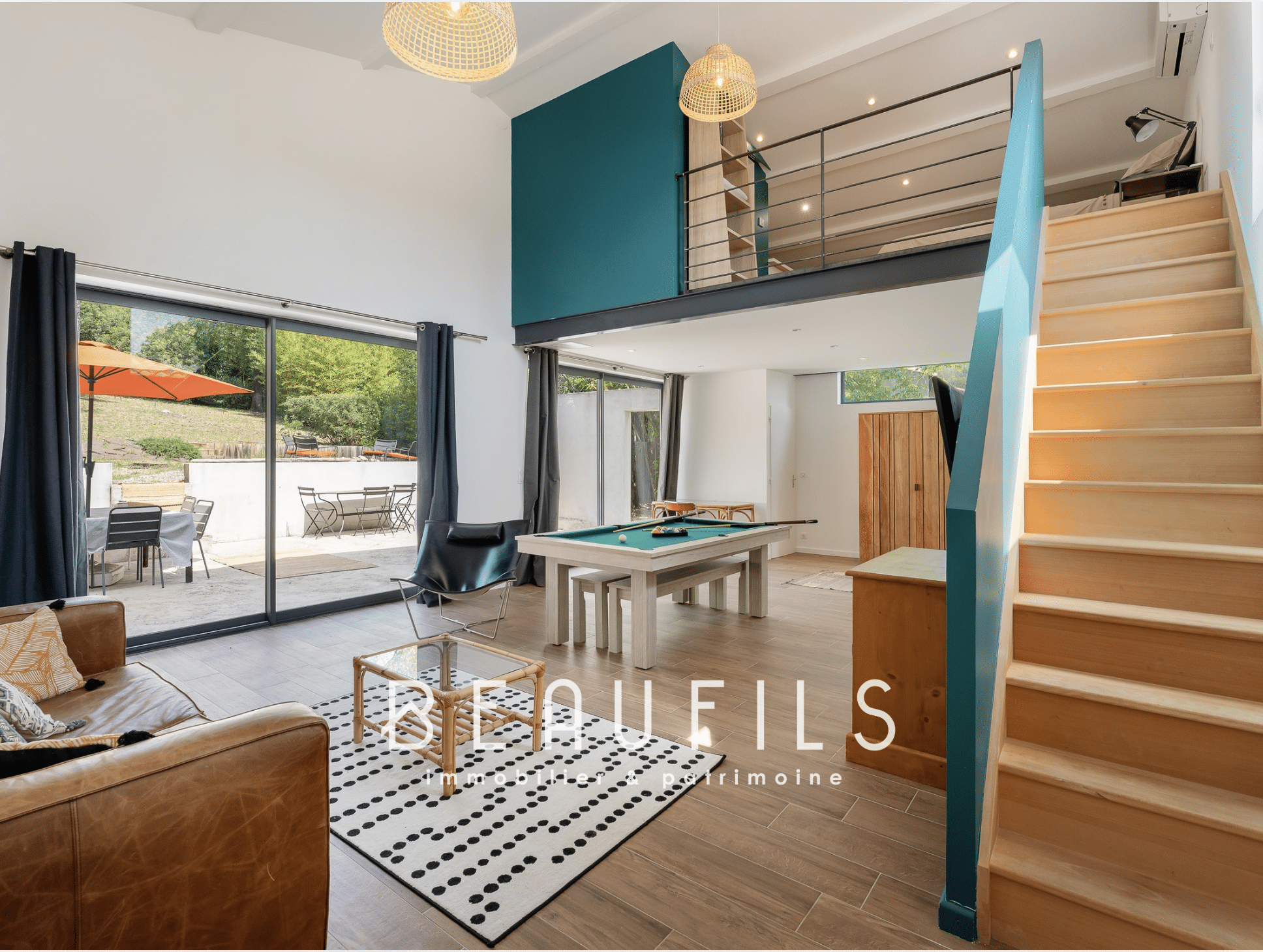Interior of an architect-designed villa with living room, billiards and outdoor access.
