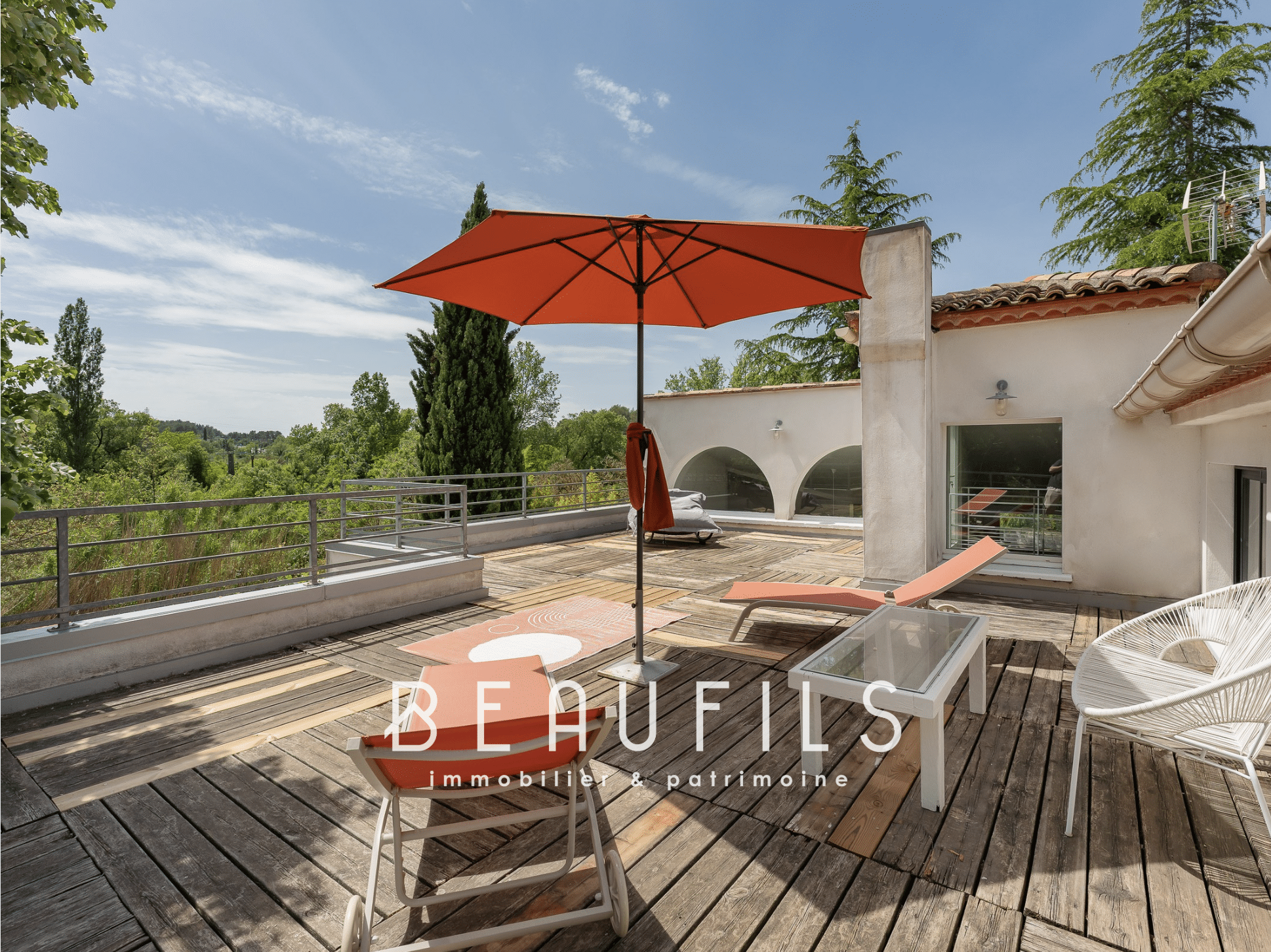 Terrace of an architect-designed villa with parasol and outdoor furniture in Montferrier-sur-Lez.