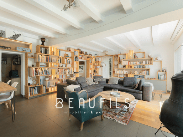 Interior of an architect-designed villa in Montferrier-sur-Lez with a large living room and wooden shelves.