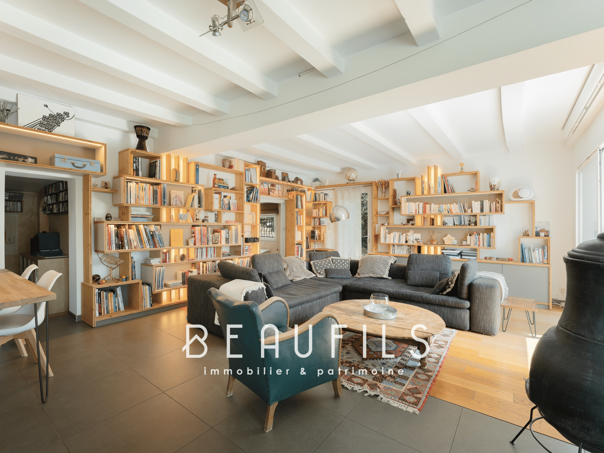 Interior of an architect-designed villa in Montferrier-sur-Lez with a large living room and wooden shelves.